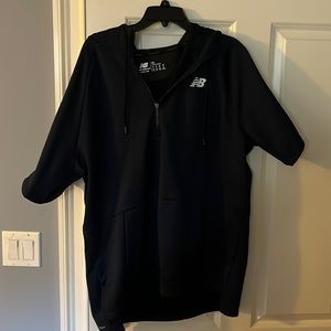 Blue Men’s New Balance short sleeve Quarter zip with a hood.